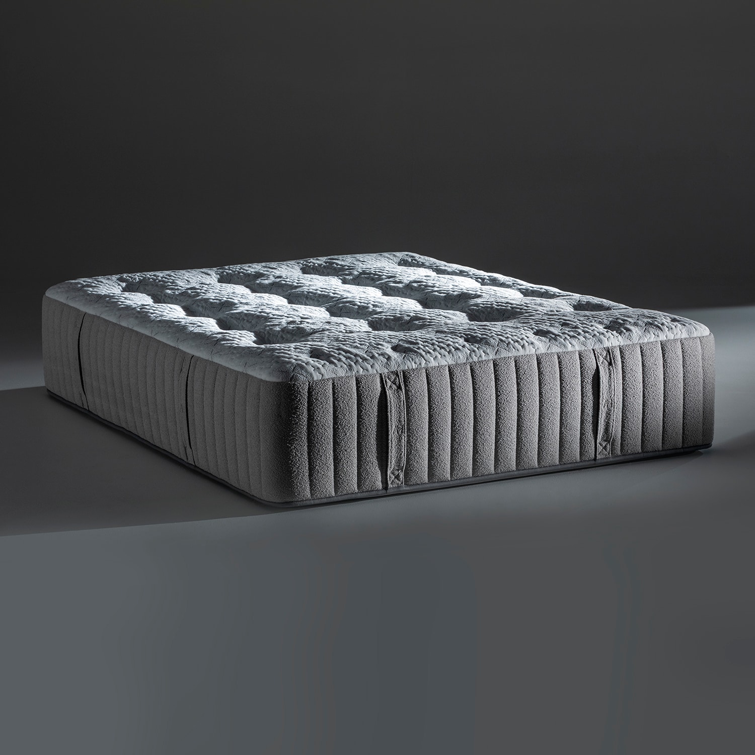 A luxury mattress against a plain background