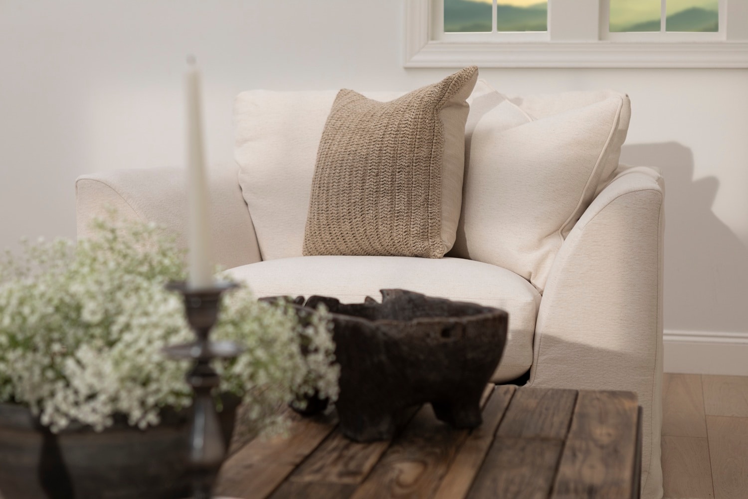 Cream colored linen sofa with flower arrangement for spring