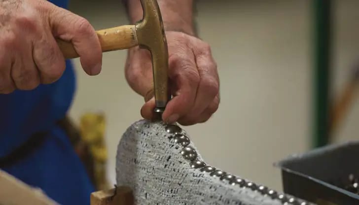 Close up of a man working on a Flexsteel sofa