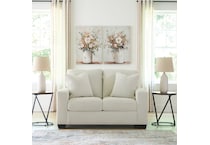 a white fab loveseat   