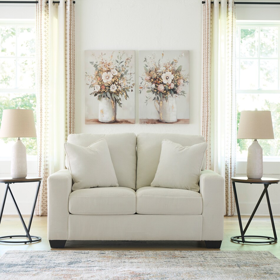 a white fab loveseat   