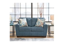 a blue fabric loveseat   