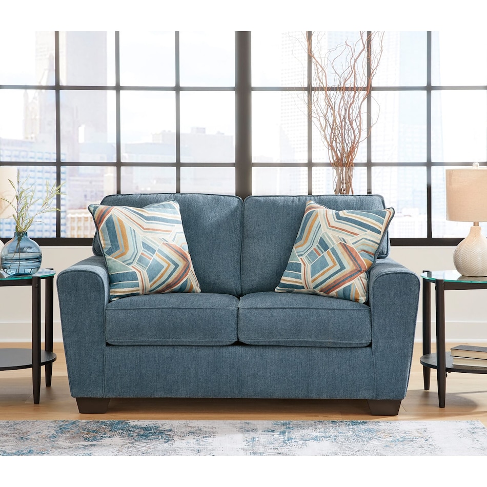 a blue fabric loveseat   