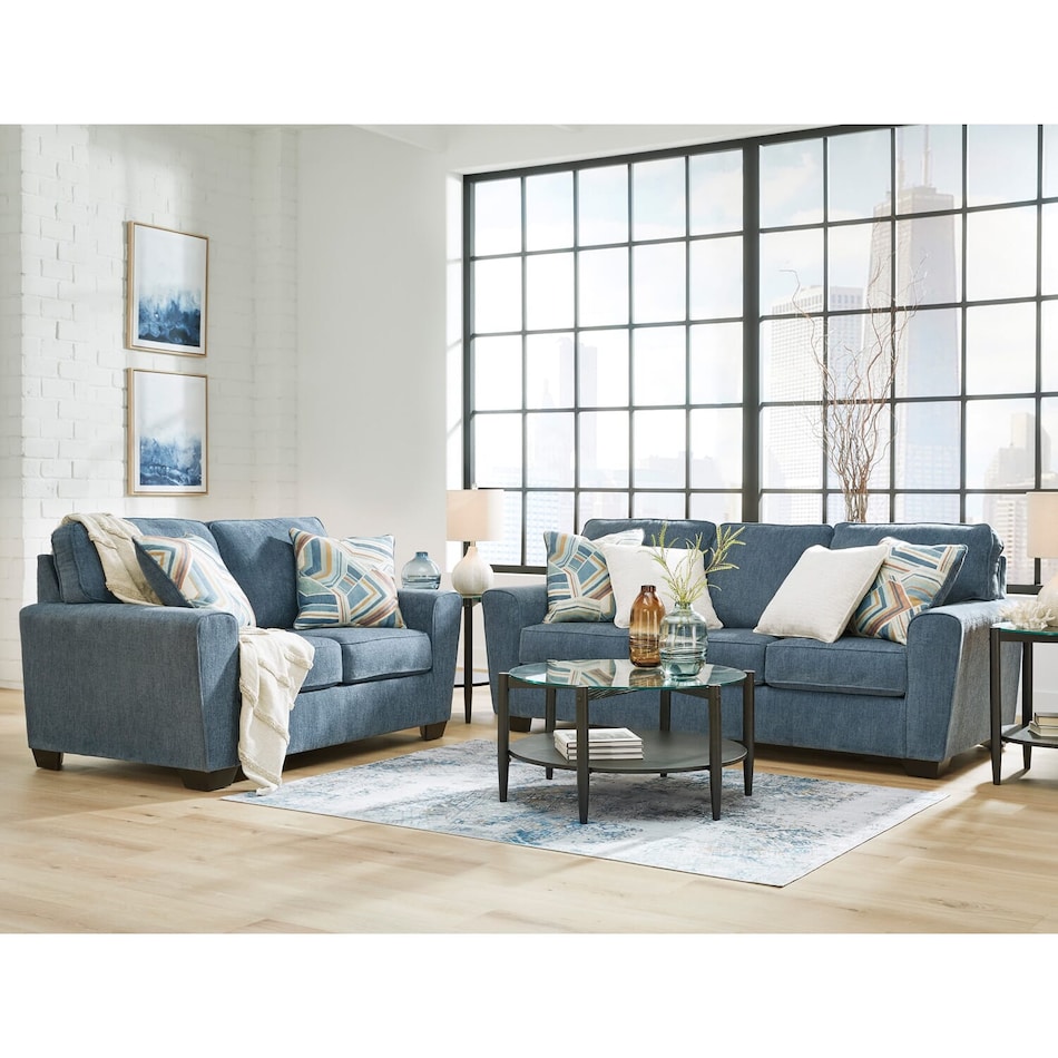 a blue fabric loveseat   