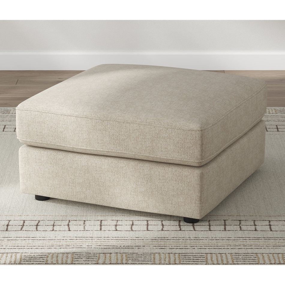 a beige fabric ottoman   