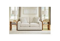 a white fabric loveseat   