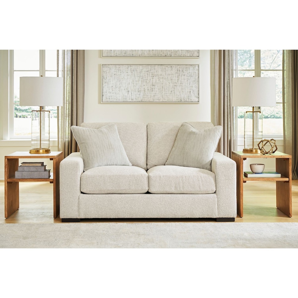 a white fabric loveseat   