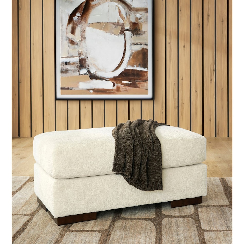 a beige fabric ottoman   